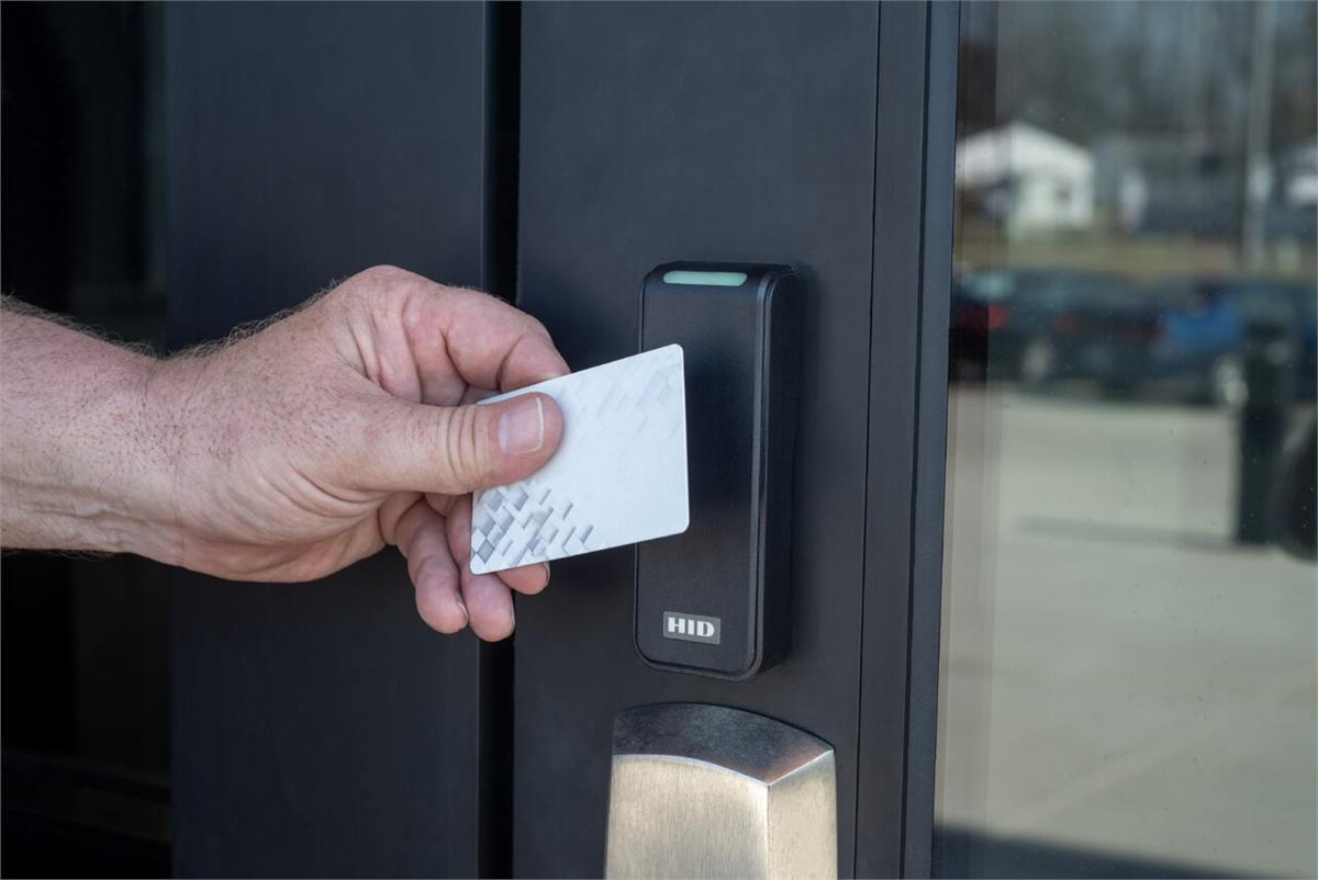 Person using an access control reader at a commercial facility