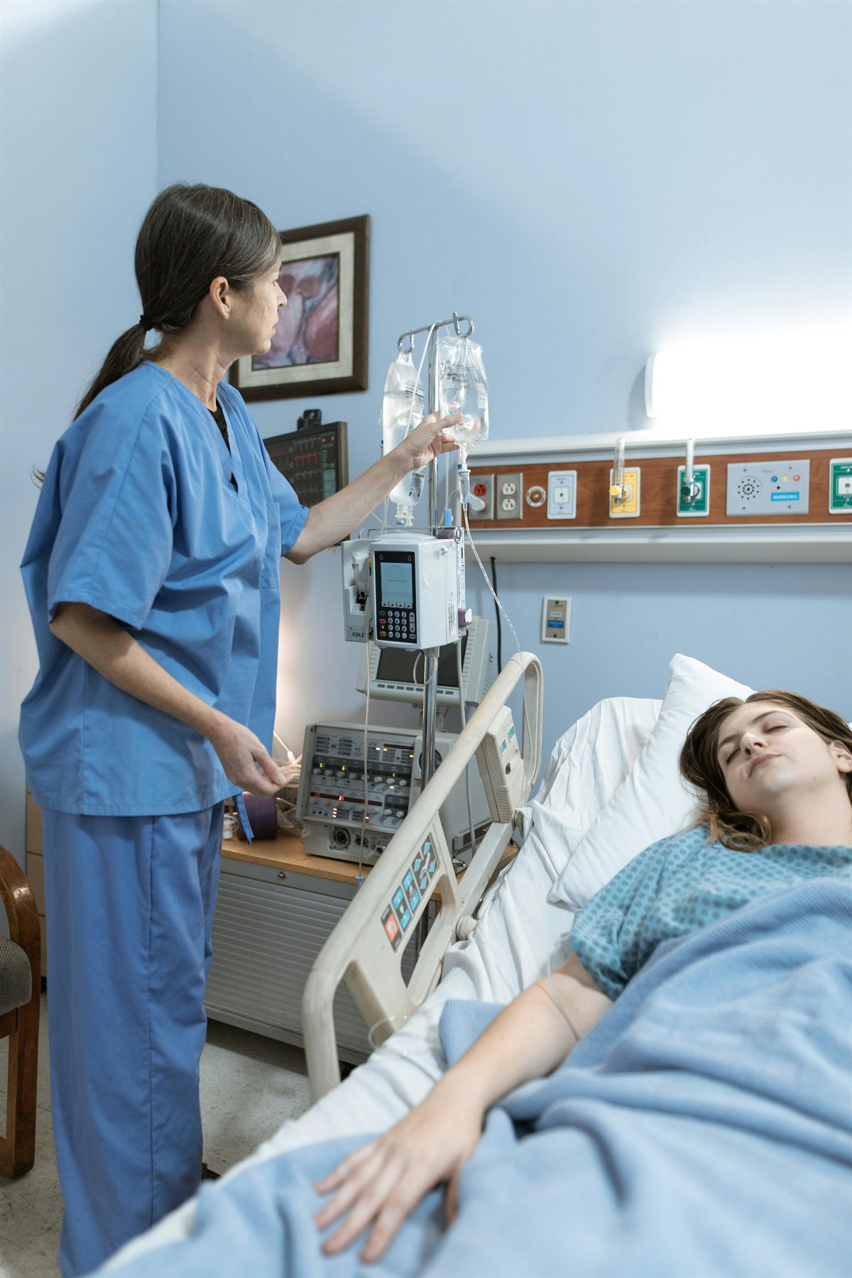 Nurse attending to a patient in a hospital room